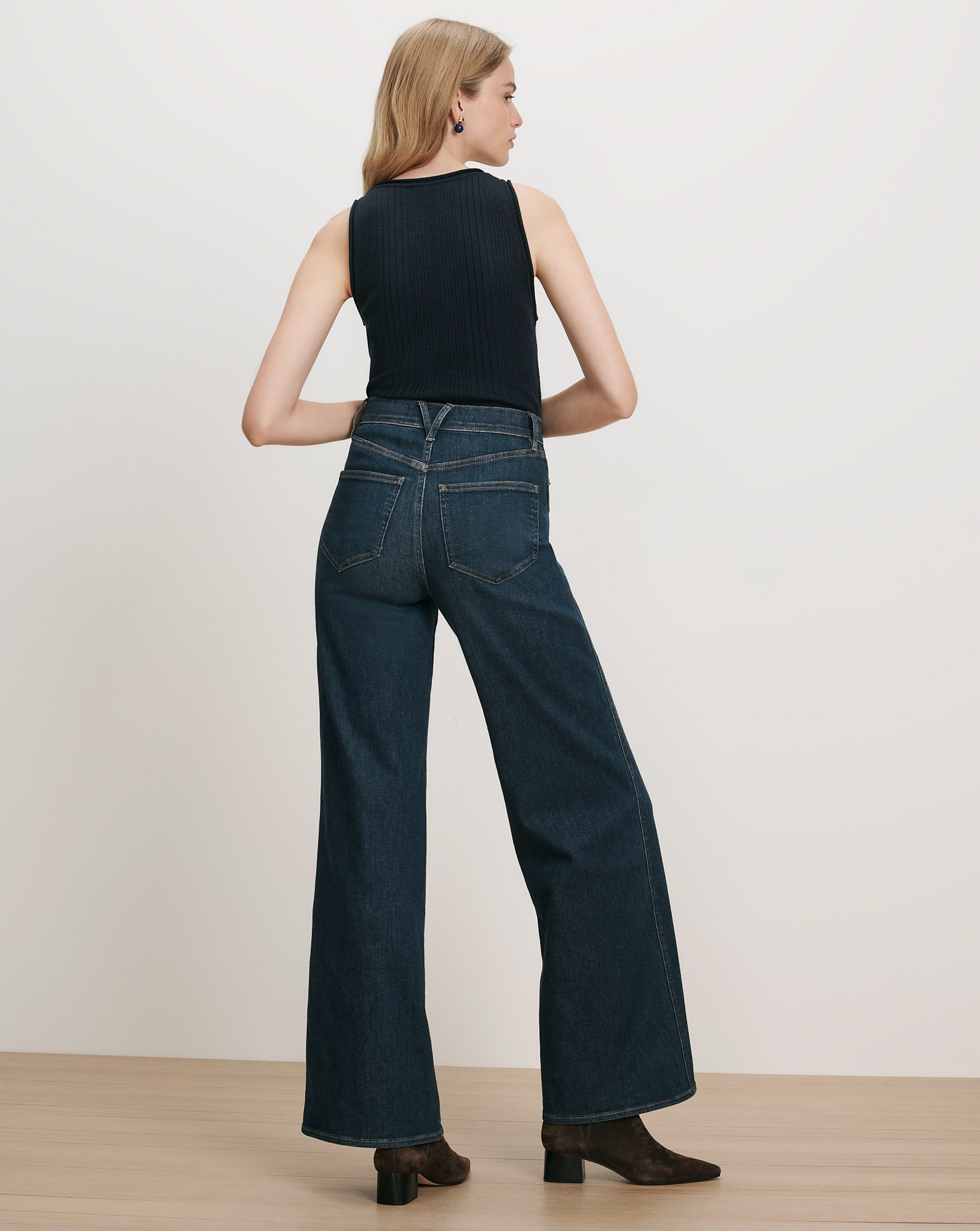 Veronica Beard Dark wash wide-leg jeans and black ribbed tank top.