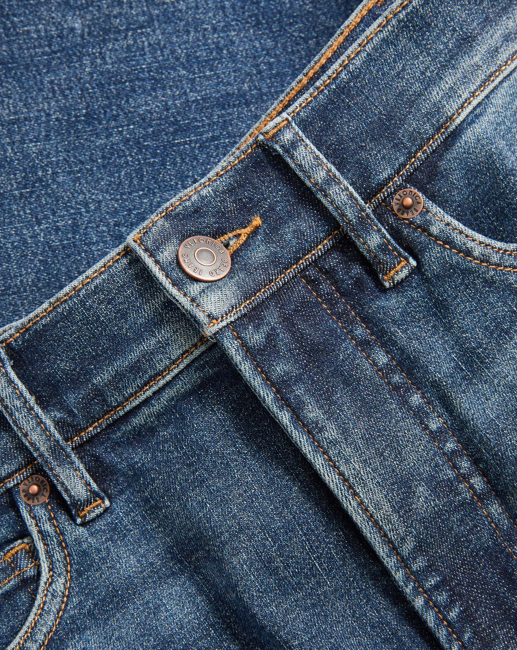 Veronica Beard Blue denim jeans with copper buttons and stitching.