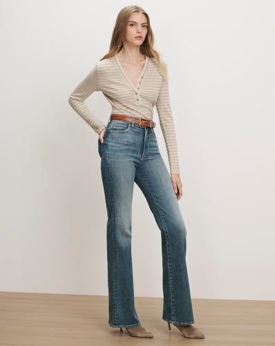 Veronica Beard Striped long-sleeve henley, blue flare jeans, brown belt.