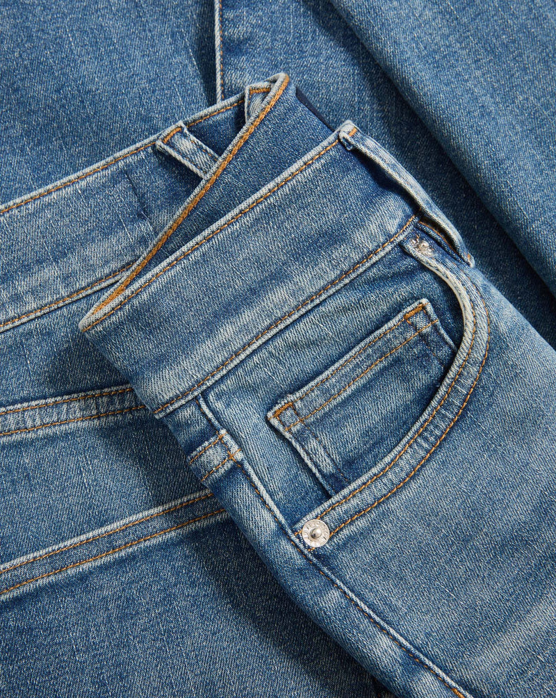 Veronica Beard Blue denim jeans with orange stitching.