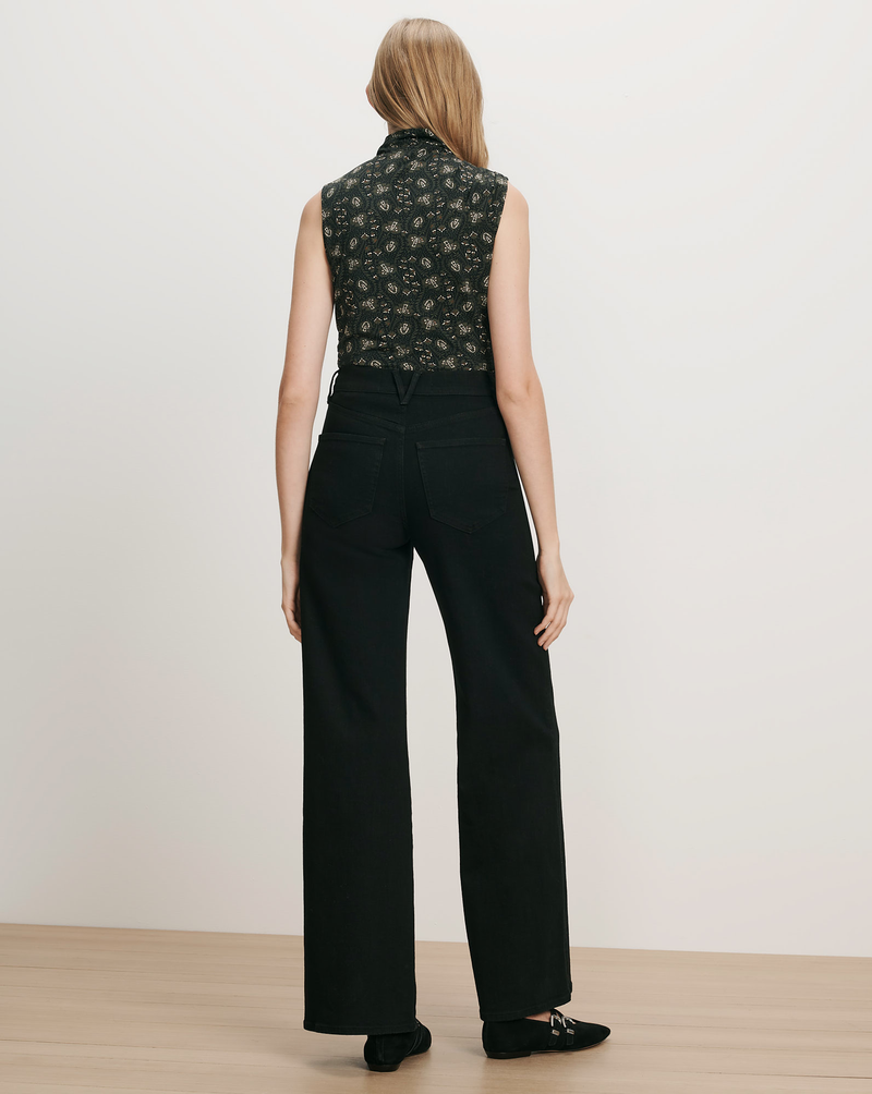 Veronica Beard Black floral sleeveless top and black wide-leg jeans.
