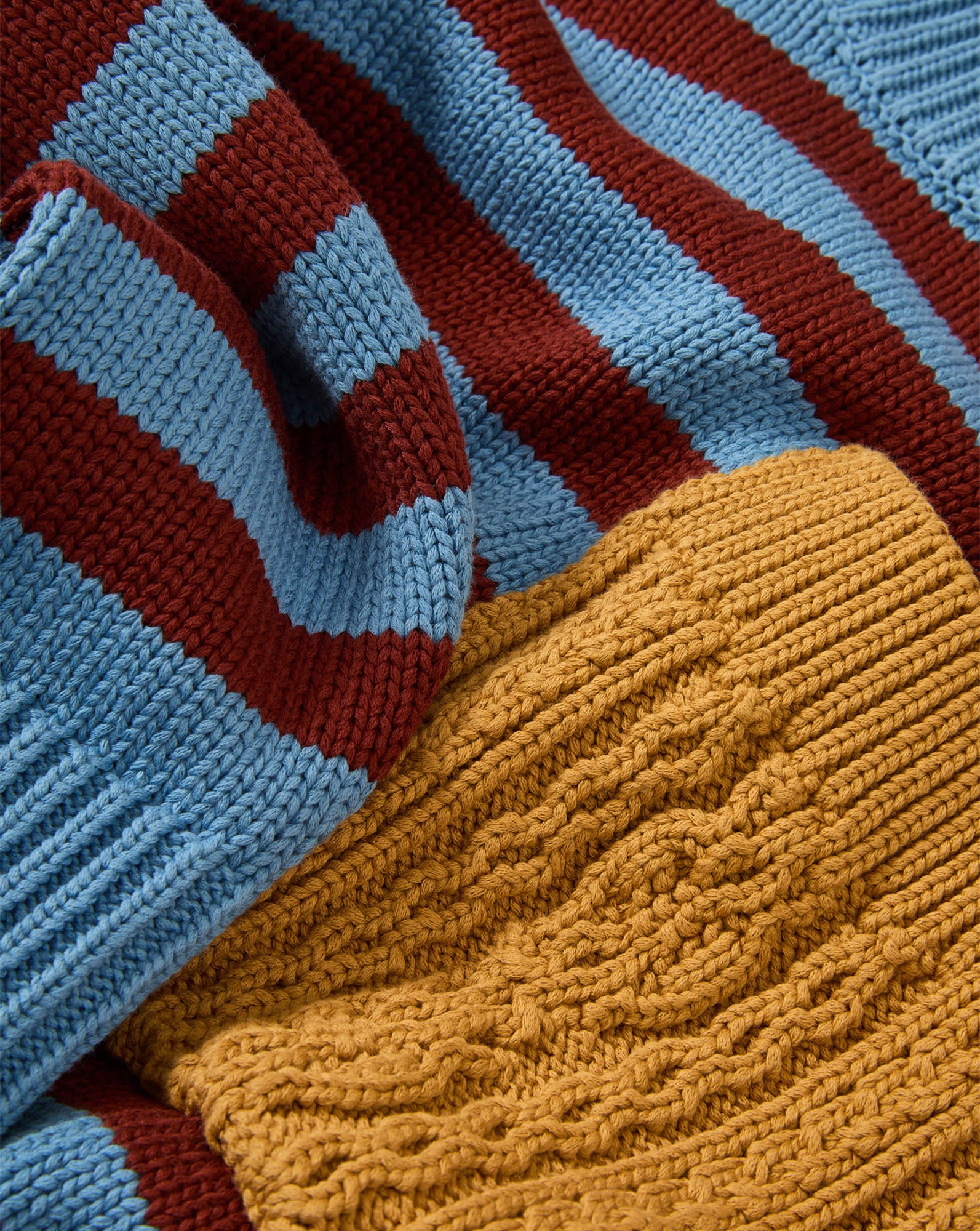 Veronica Beard Blue and red striped knit sweater, yellow cable knit sweater.