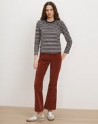 Veronica Beard Navy and white striped long-sleeve shirt, rust corduroy pants.