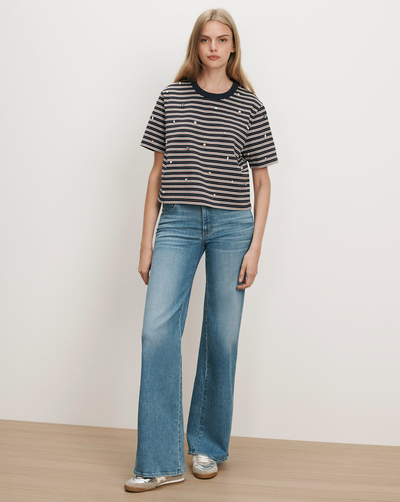 Veronica Beard Striped t-shirt with embroidered stars and wide-leg jeans.