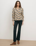 Veronica Beard Plaid long-sleeve blouse and dark wash flare jeans.