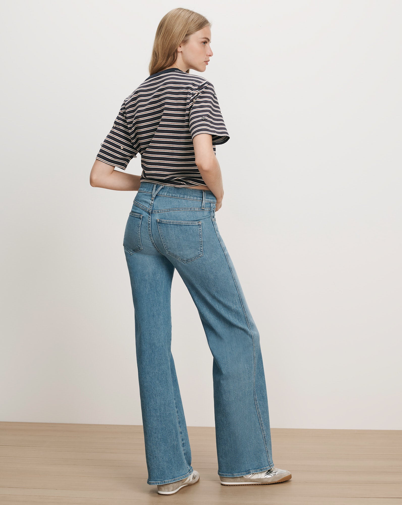 Veronica Beard Blue denim flared jeans and striped t-shirt.