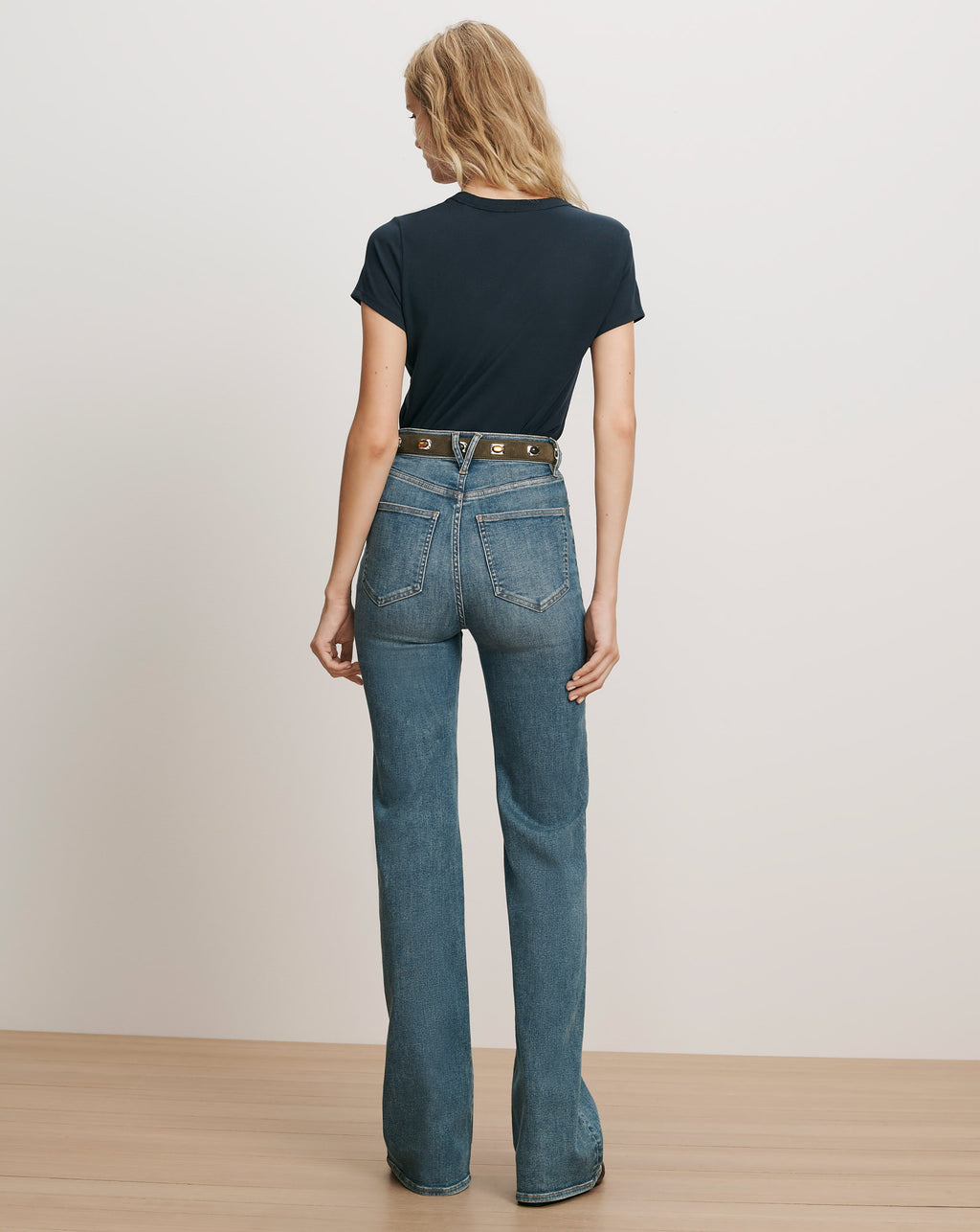 Veronica Beard Navy t-shirt and blue flared jeans.