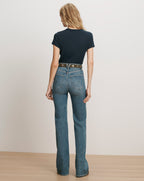Veronica Beard Navy t-shirt and blue flared jeans.