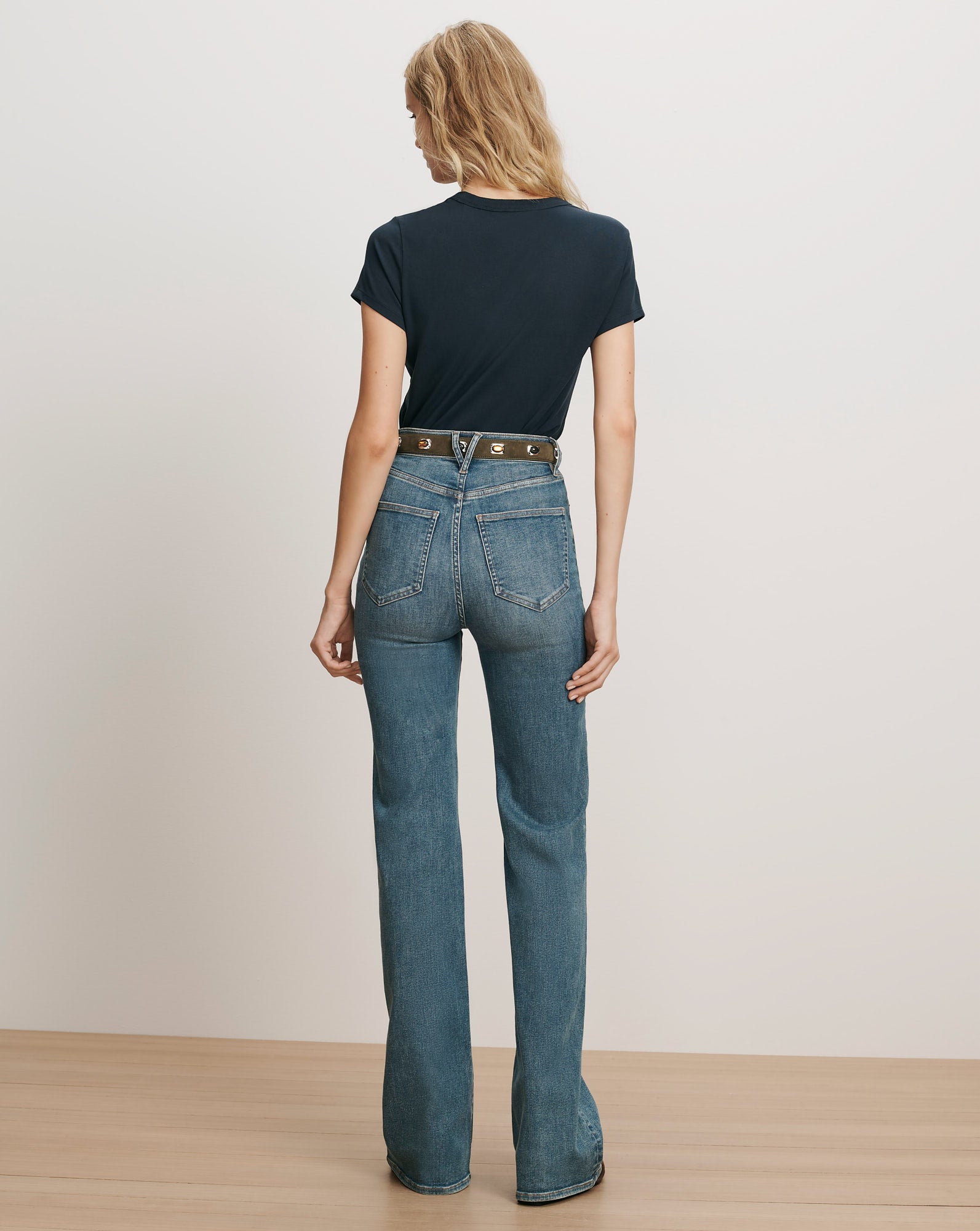 Veronica Beard Navy t-shirt and blue flared jeans.