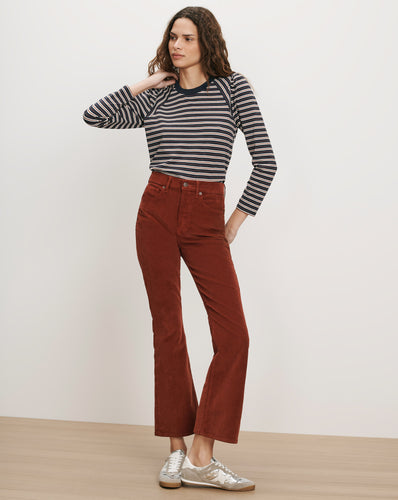 Veronica Beard Brown corduroy flare pants and striped long-sleeve shirt.
