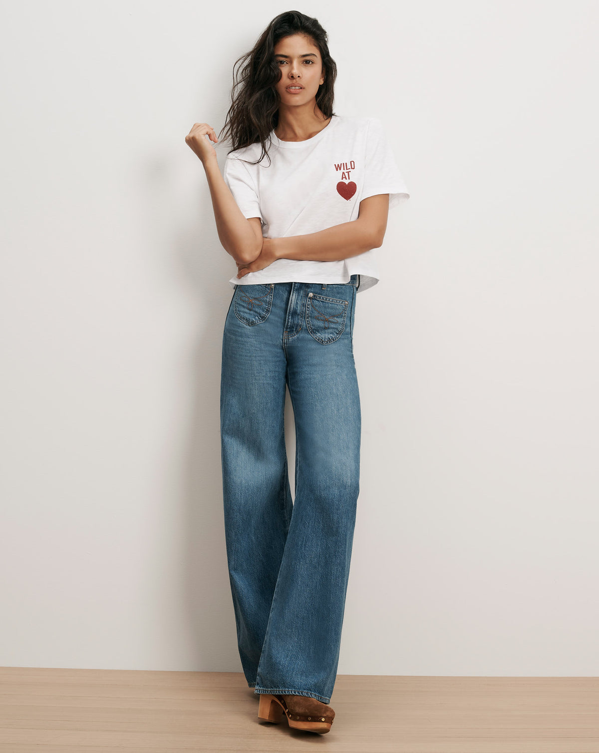 Veronica Beard White graphic tee and wide-leg jeans.