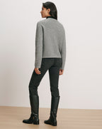 Veronica Beard Gray crewneck sweater, black jeans, black leather boots.