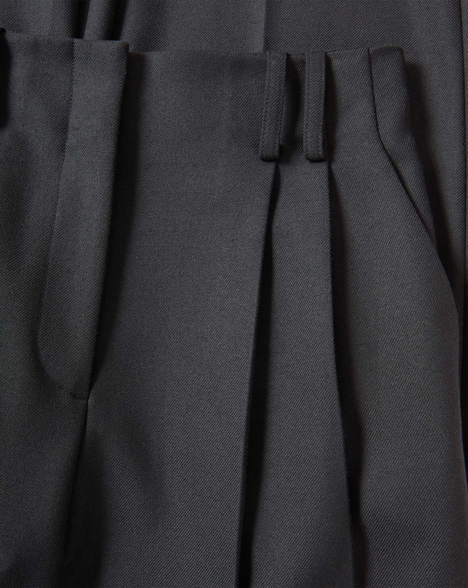 Veronica Beard Black pleated trousers in a woven fabric.