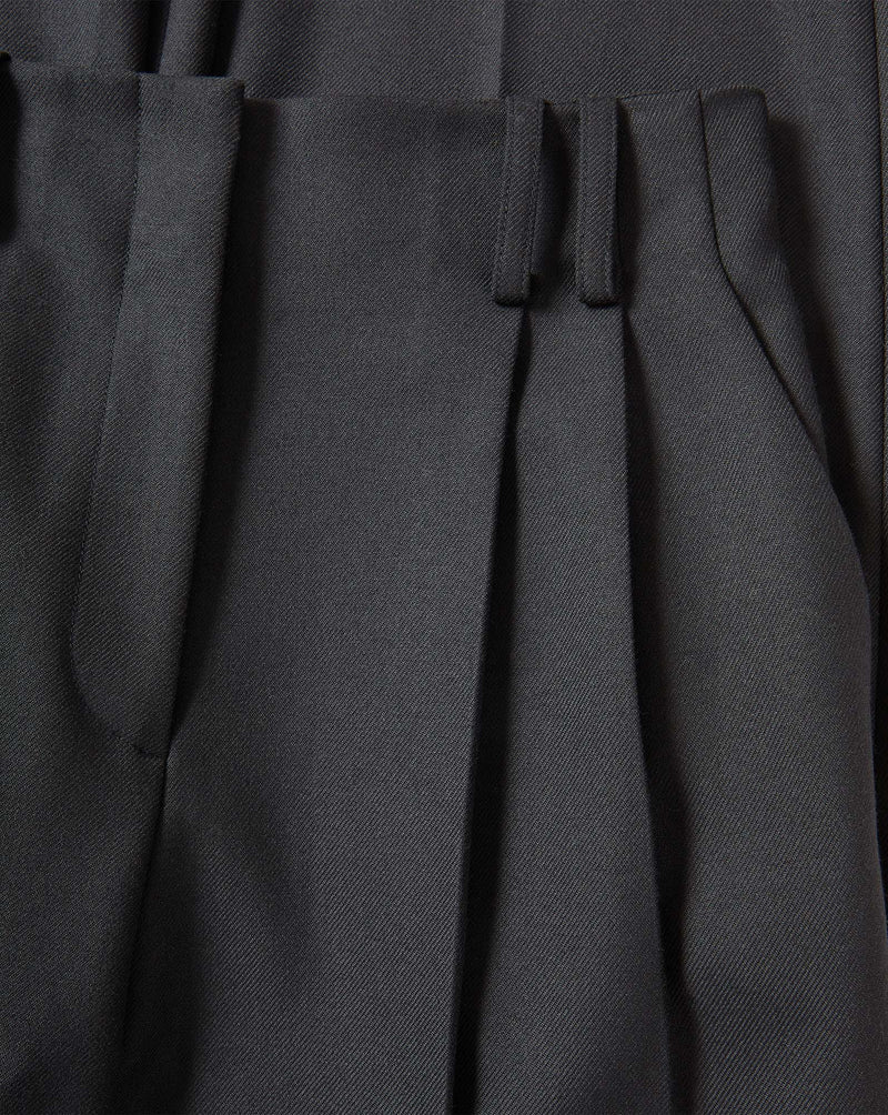Veronica Beard Black pleated trousers in a woven fabric.