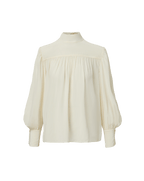 Veronica Beard Cream high-neck blouse with pleated front and puff sleeves.
