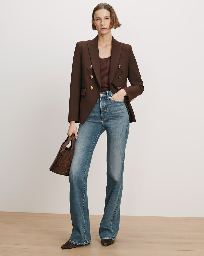 Veronica Beard Brown blazer, brown tank top, blue flare jeans.