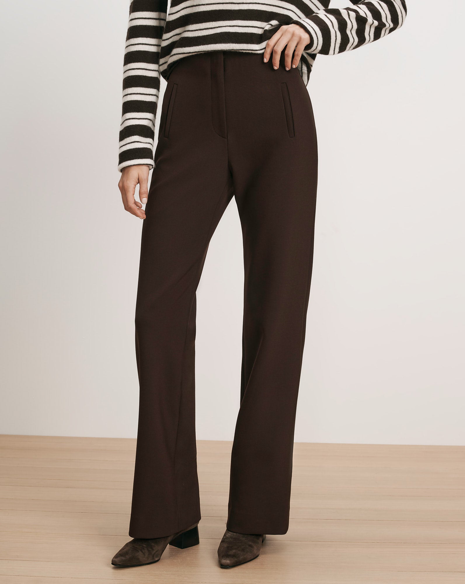 Veronica Beard Brown wide-leg trousers with a striped sweater.