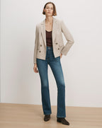 Veronica Beard Beige double-breasted blazer, brown tank top, blue flare jeans.