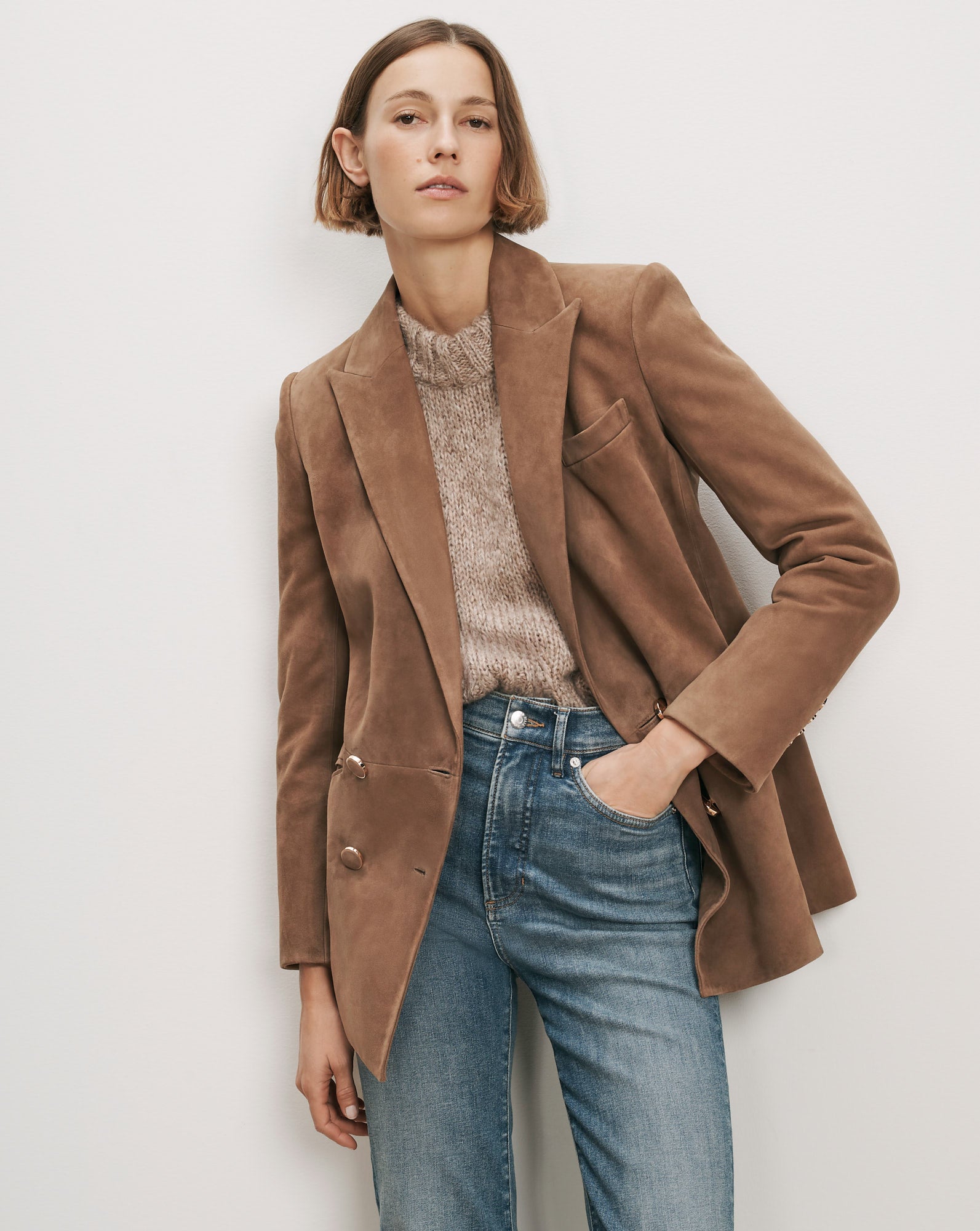 Veronica Beard Brown suede blazer, knit sweater, and blue jeans.