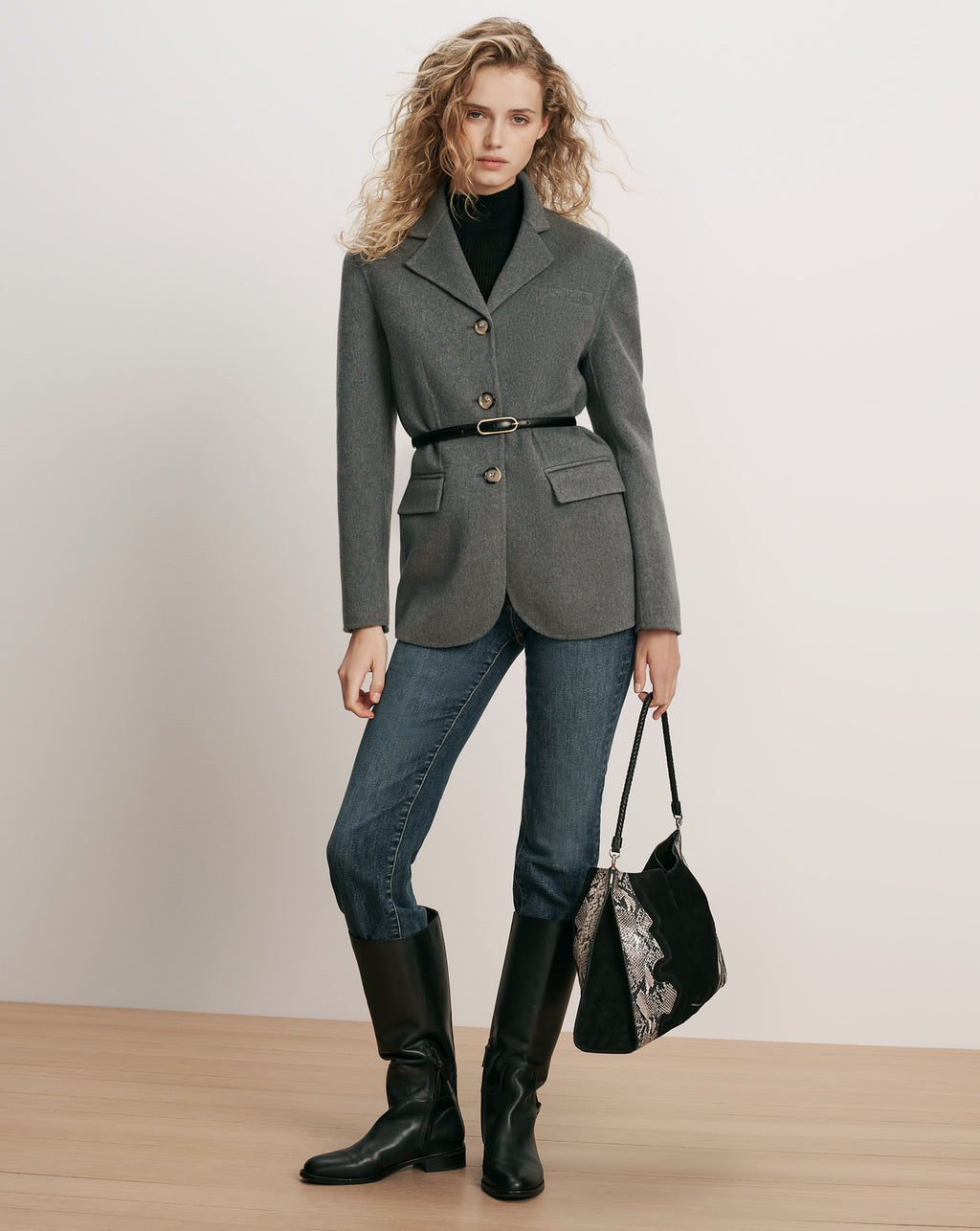 Veronica Beard Gray wool blazer, belted, with black turtleneck and jeans.