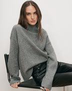 Veronica Beard Gray turtleneck sweater, black leather pants.
