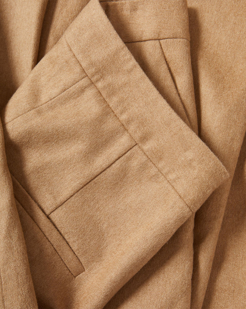 Veronica Beard Tan textured fabric folded with pleats.