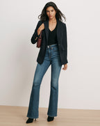 Veronica Beard Navy blazer, black top, blue flare jeans.