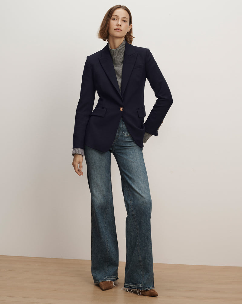 Veronica Beard Navy blazer, gold buttons, and flared jeans.