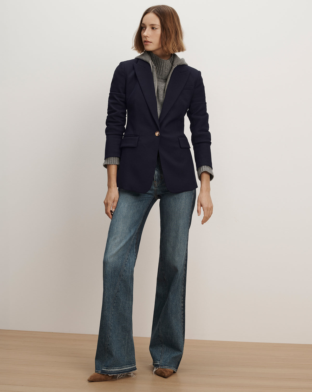 Veronica Beard Navy blue tailored blazer and flared blue jeans.