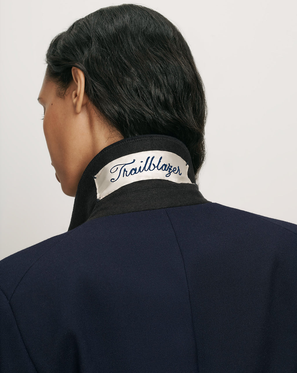 Veronica Beard Navy blazer with white Trailblazer collar patch.