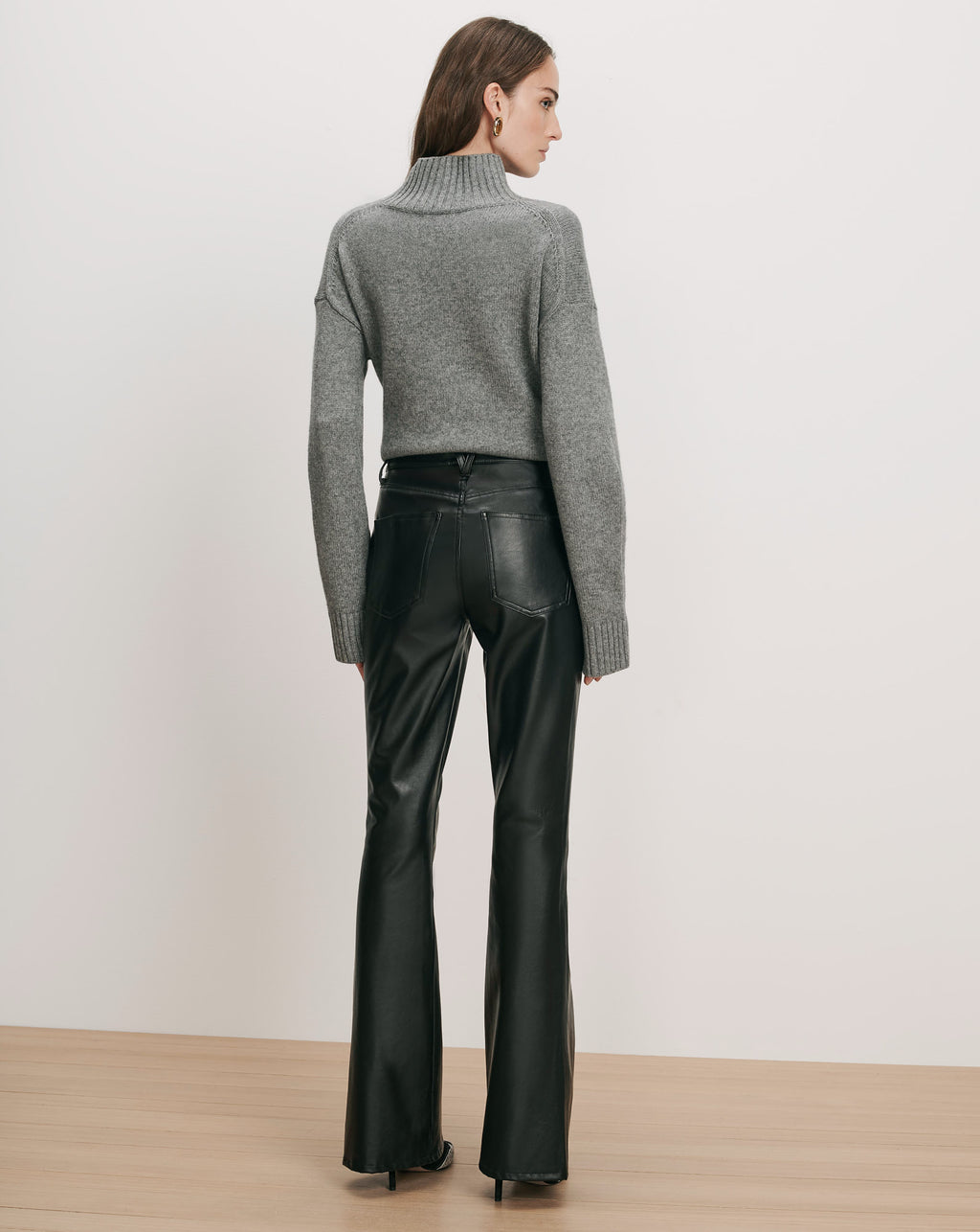 Veronica Beard Gray knit turtleneck sweater and black leather pants.