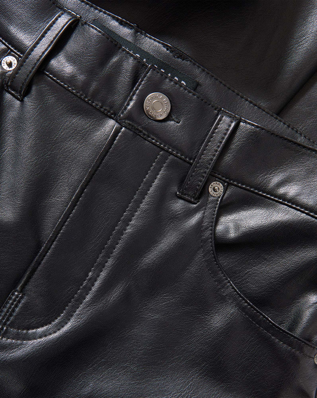 Veronica Beard Black faux leather pants with silver button details.