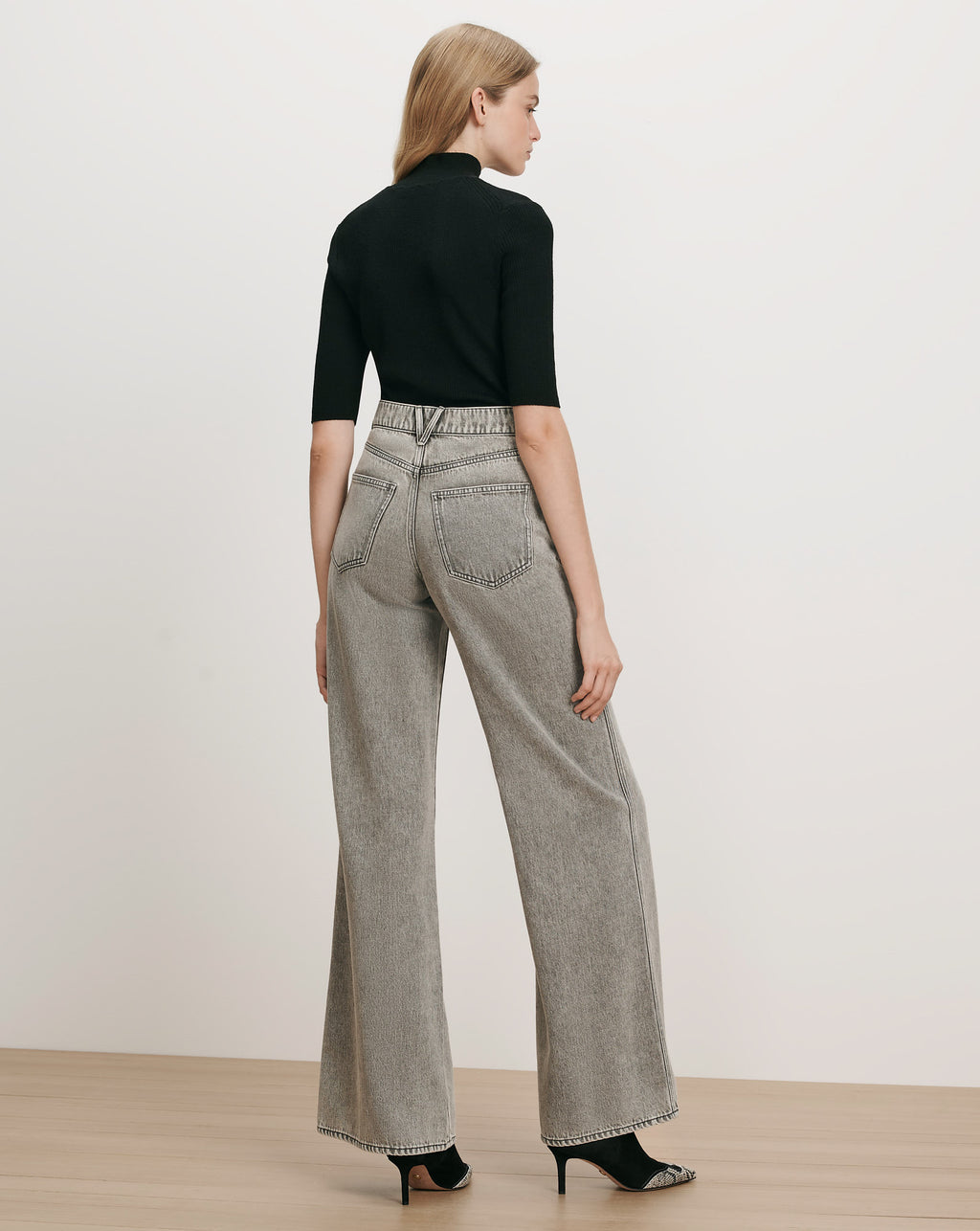 Veronica Beard Black ribbed turtleneck top, gray wide-leg jeans