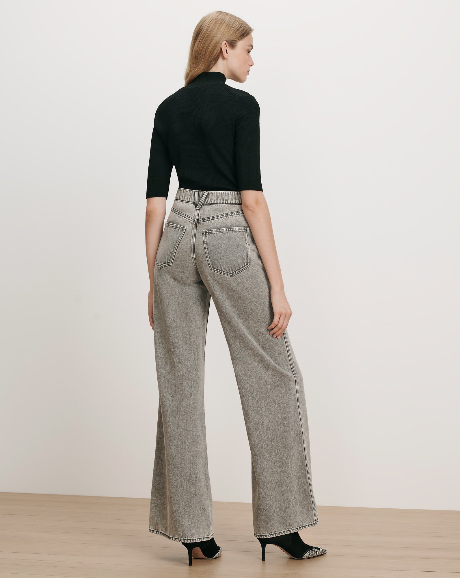 Veronica Beard Black ribbed turtleneck top, gray wide-leg jeans