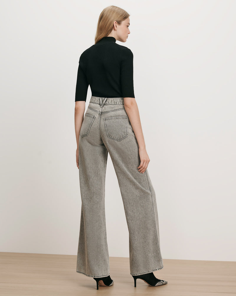 Veronica Beard Black ribbed turtleneck top, gray wide-leg jeans