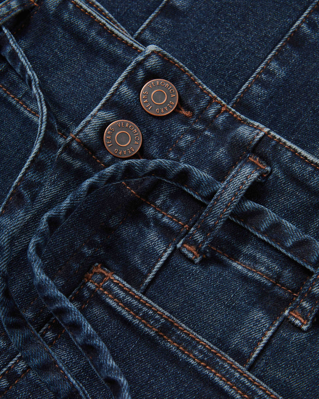 Veronica Beard Blue denim jeans with bronze buttons and stitching.