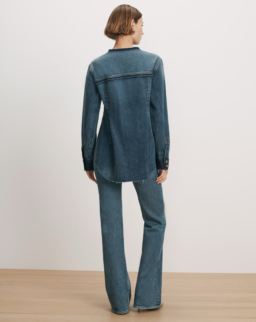 Veronica Beard Blue denim shirt and flared jeans.