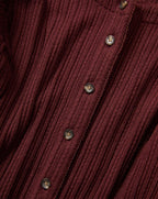 Veronica Beard Burgundy ribbed knit cardigan with brown buttons.