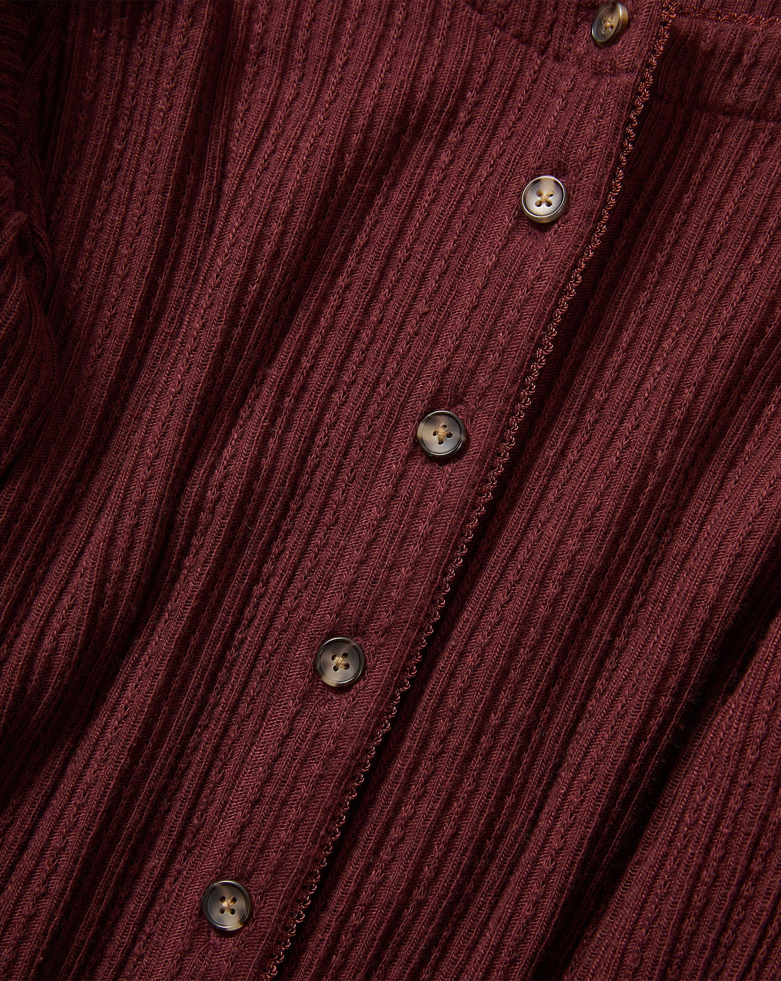 Veronica Beard Burgundy ribbed knit cardigan with brown buttons.