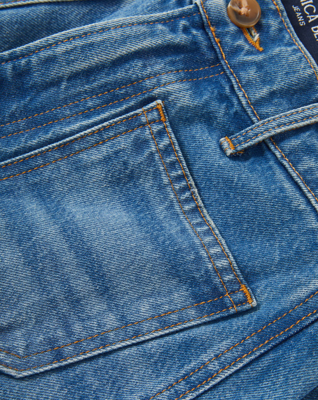 Veronica Beard Blue denim jeans with orange contrast stitching.