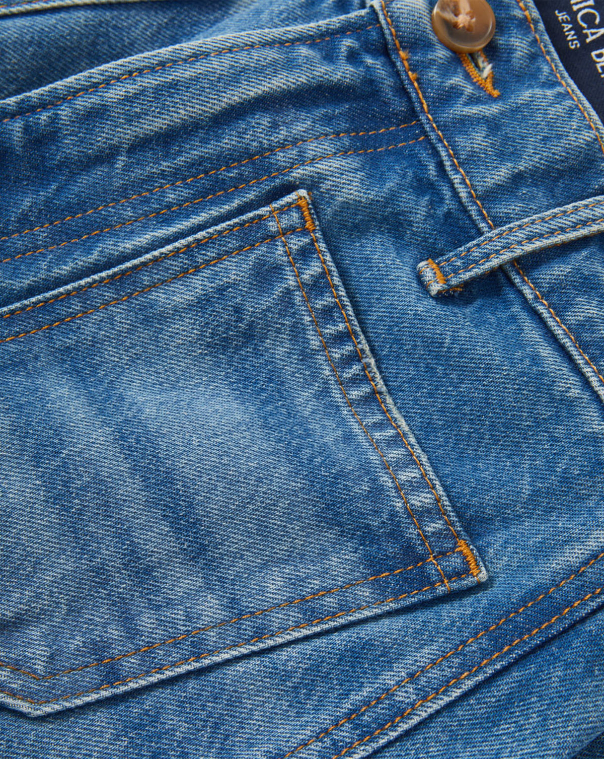 Veronica Beard Blue denim jeans with orange contrast stitching.