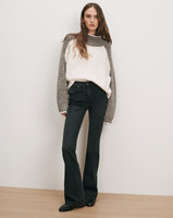 Veronica Beard Color-block raglan sweater and dark wash flare jeans.