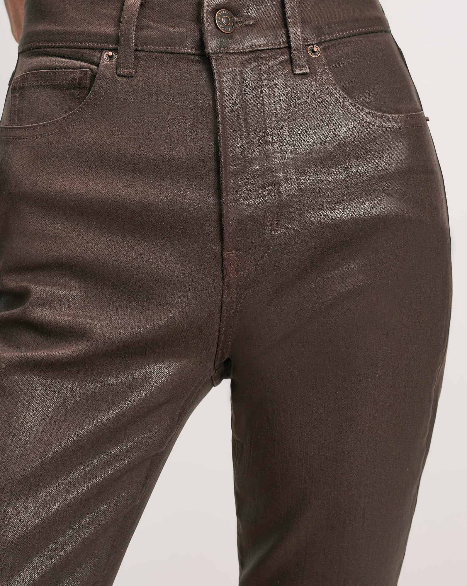 Veronica Beard Brown coated denim jeans with five pockets.