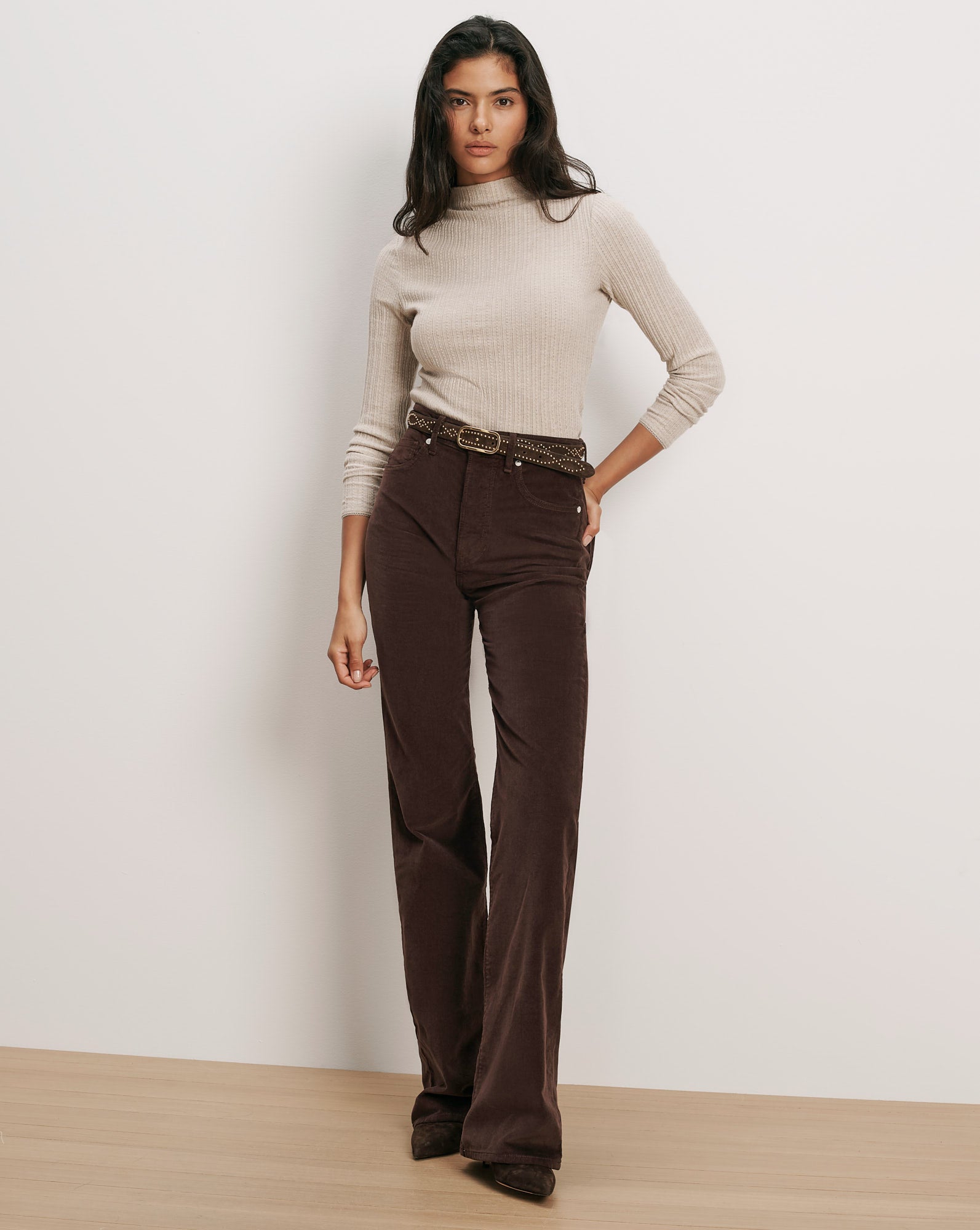 Veronica Beard Beige ribbed turtleneck, brown corduroy pants, studded belt.