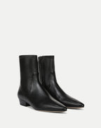 Veronica Beard Black leather ankle boots with pointed toes.