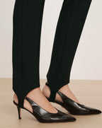 Veronica Beard Black stirrup pants with black slingback heels.