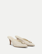 Veronica Beard Cream leather mules with gold and pink stone detail.