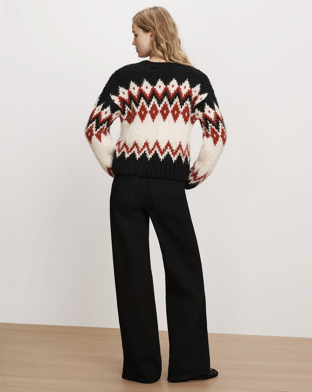 Veronica Beard Black fair isle patterned knit sweater with jeans.