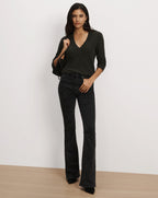 Veronica Beard Dark grey V-neck sweater and black flared jeans.
