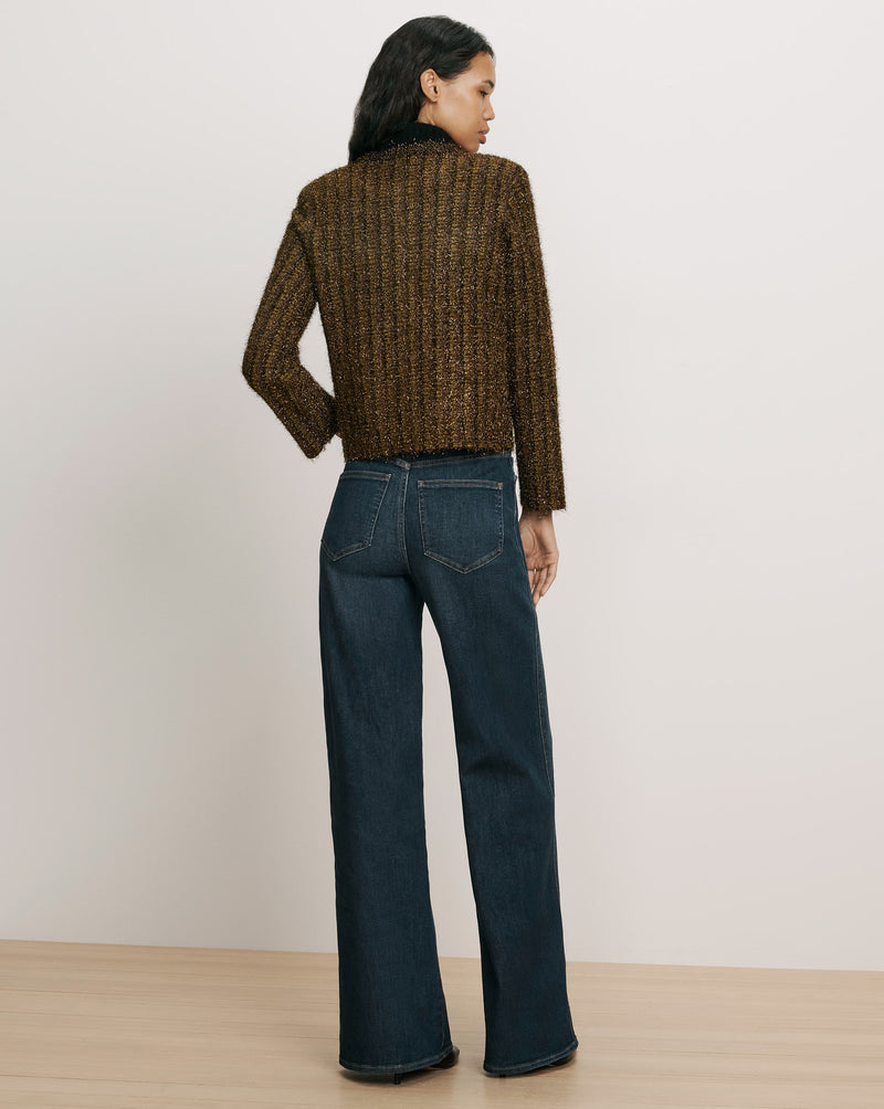 Veronica Beard Brown tweed jacket and blue denim jeans.